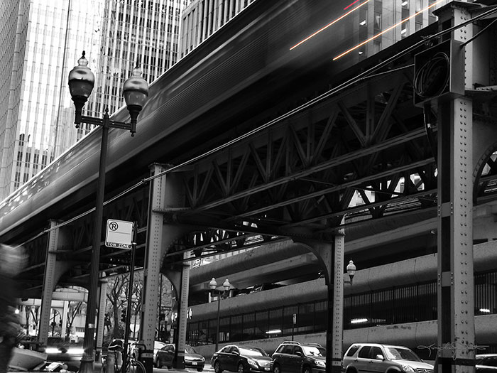 Chicago L train speeding by in black and white