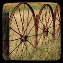 Close up view of part of a metal wagon wheel fence/