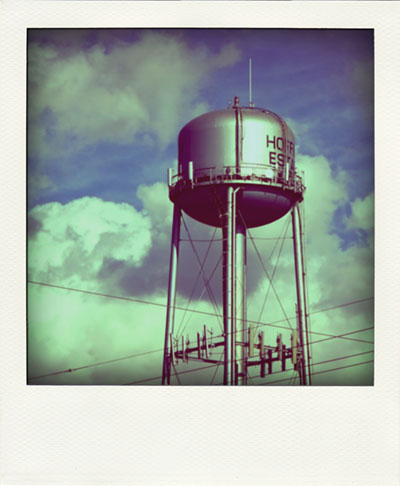 Water Tower with billowy clouds on a sunny day