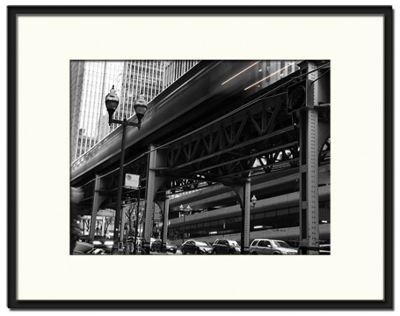 Black & White Chicago L (elevated) train speeding by.